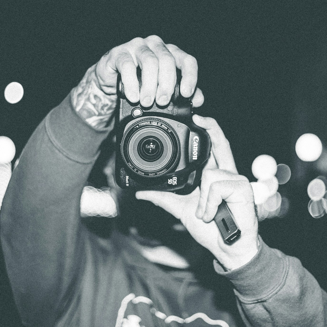 A man holds a camera up to the camera